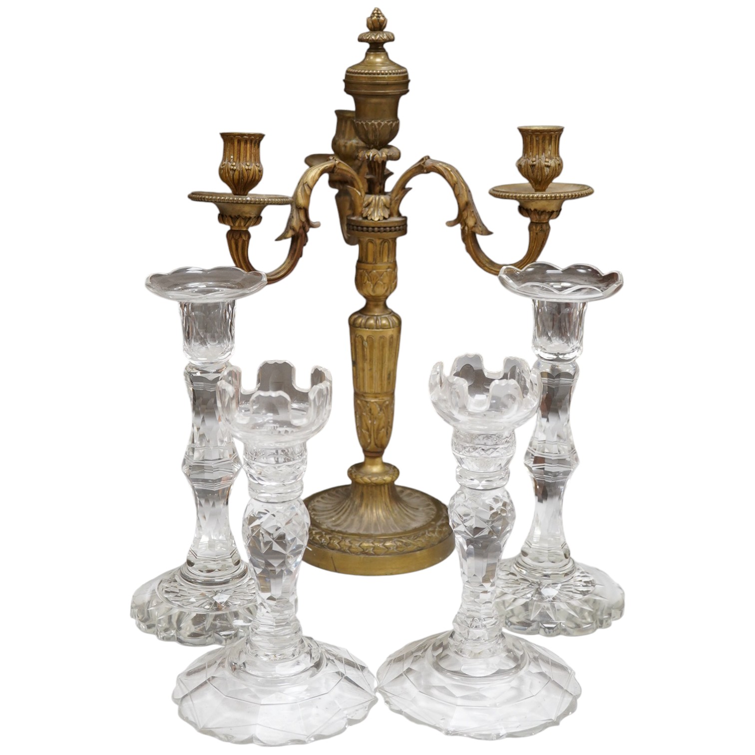 Two pairs of cut glass candlesticks and a gilt metal three branch candelabra, largest 44cm high. Condition - fair, some minor chipping